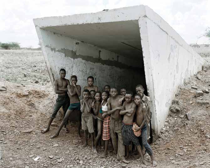 Children of Pomfret at the entrance to the incline shaft and underground pool of water in which they swim. Pomfret Blue Asbestos Mine, which closed in 1986, North West Province. 20 December 2002 by David Goldblatt at Annandale Galleries